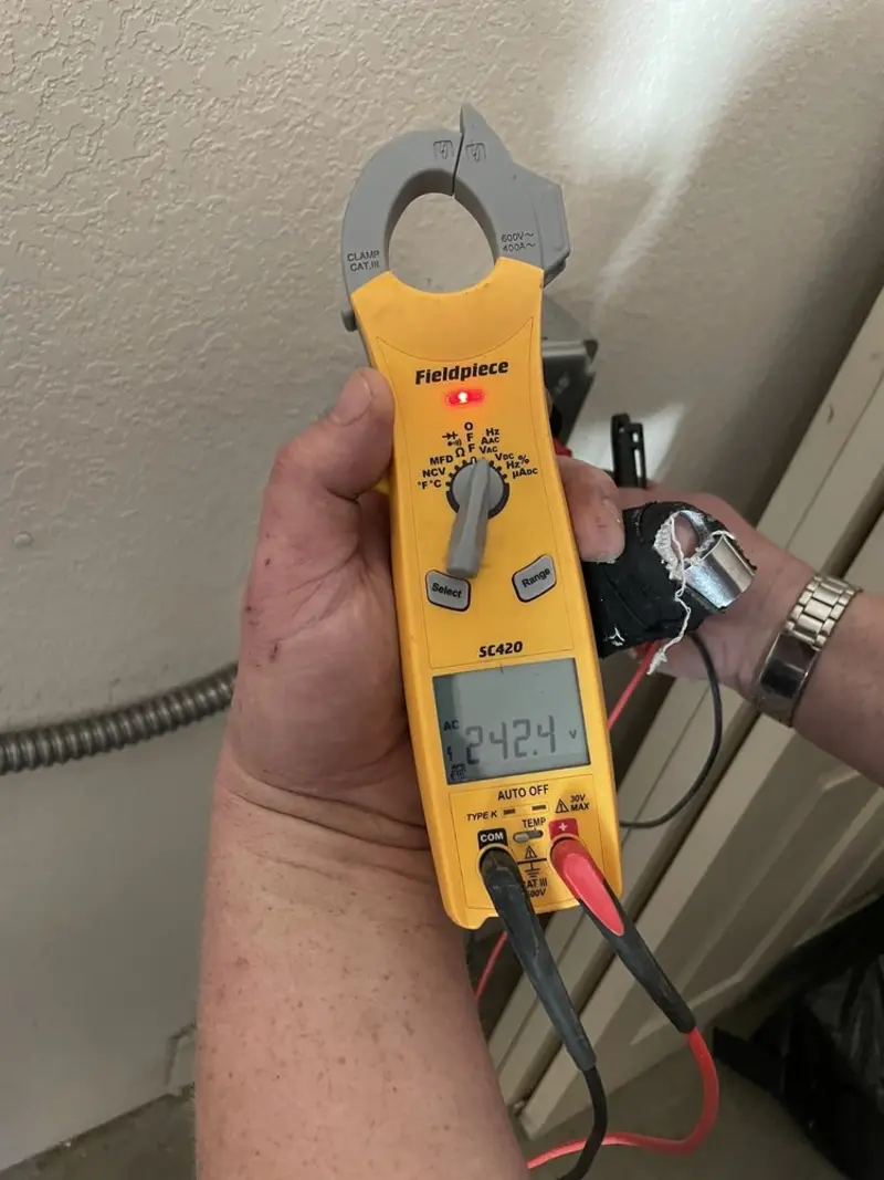 Voltage testing with clamp meter during Ceiling Fan Installation in Columbus